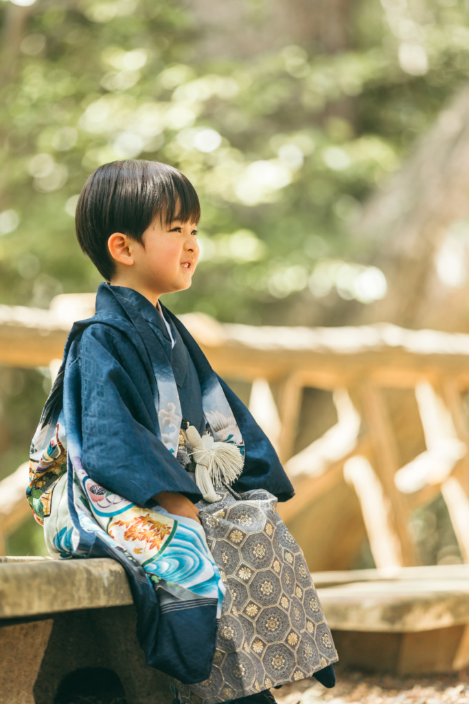 椅子に座り目線を外した3歳男の子の七五三写真